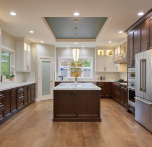 two-tone kitchen with quartz countertop and glass mosaic backsplash